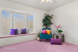 Sitting room with light carpet and ceiling fan