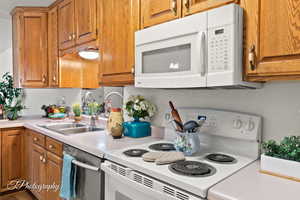 Kitchen with white appliances and sink