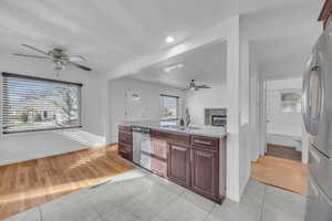 Kitchen with hardwood flooring, stainless steel appliances, plenty of natural light, and sink