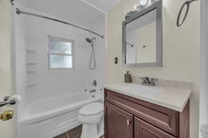 Full bathroom featuring tile patterned floors, vanity, shower / bathtub combination, and toilet