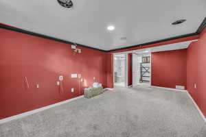 Carpeted empty room with crown molding and speaker ready