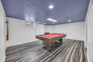 Game room featuring dark hardwood / wood-style tile flooring,  and billiards