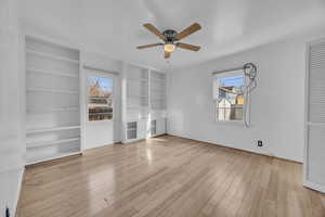 Bedroom featuring ceiling fan, plenty of natural light, and hardwood floors