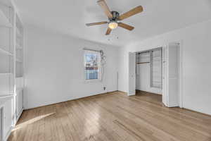 Unfurnished bedroom featuring ceiling fan and hardwood flooring