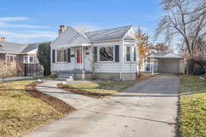 Bungalow featuring a garage, and a lovely front yard