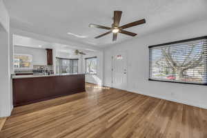 Living room featuring large windows and hardwood floors