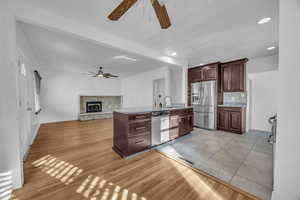 Kitchen with a center island with sink, hardwood floors, sink, and appliances with stainless steel finishes