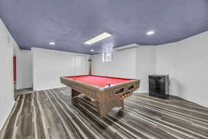 Rec room with dark hardwood / wood-style tile flooring, and pool table