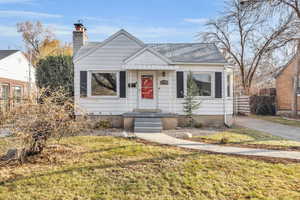 Bungalow-style home with mature trees and lovely front yard