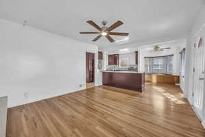 Kitchen with tile and hardwood floors, kitchen peninsula, and tasteful backsplash