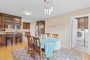 Dining room featuring washer and clothes dryer and light hardwood / wood-style flooring