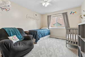 Bedroom featuring ceiling fan and carpet