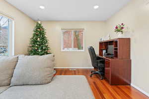 Home office with hardwood / wood-style flooring