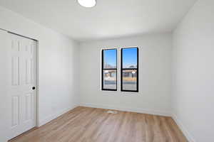 Spare room with light wood-type flooring