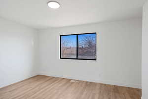 Spare room featuring light hardwood / wood-style floors