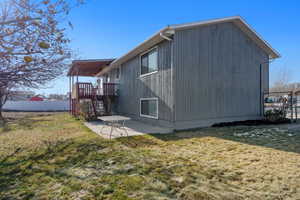 Back of property with a yard and a patio area