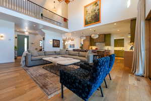 Living room featuring a high ceiling and light wood-type flooring