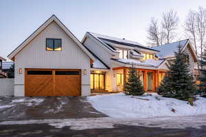 Modern farmhouse style home featuring a garage