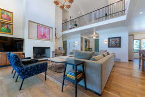 Living room featuring a high ceiling and light hardwood / wood-style flooring