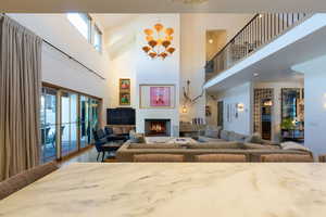 Living room with hardwood / wood-style flooring, a wealth of natural light, and a high ceiling