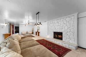 Living room with a fireplace and an inviting chandelier