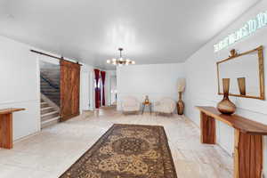 Interior space with a notable chandelier and a barn door