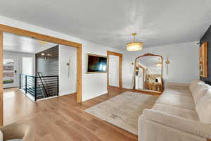 Living room featuring hardwood / wood-style flooring and a chandelier