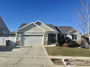 View of front facade with a front yard and a garage