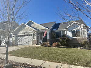 Craftsman-style house with a garage and a front yard