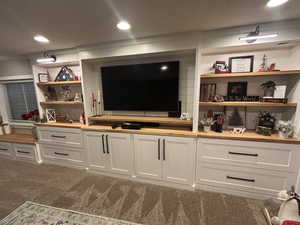 Interior space featuring white cabinetry and carpet floors