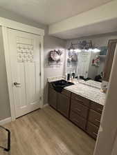 Bathroom with hardwood / wood-style floors and vanity