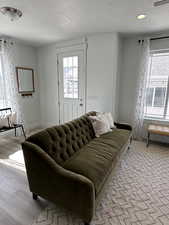 Living room with light hardwood / wood-style flooring and a textured ceiling