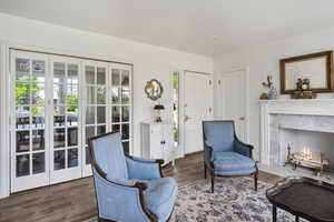 Living area with a premium fireplace and dark hardwood / wood-style flooring