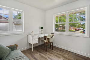 Home office featuring plenty of natural light and dark hardwood / wood-style flooring