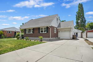 View of front of property with a garage and a front yard