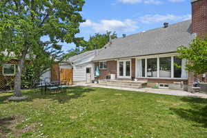 Back of property featuring a lawn