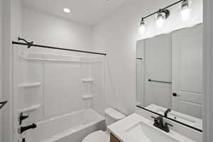 Full bathroom featuring vanity, shower / bathtub combination, and toilet