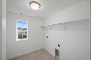 Clothes washing area with washer hookup and electric dryer hookup