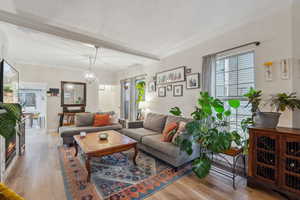 Living room featuring hardwood / wood-style floors, crown molding, and a textured ceiling