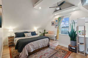 Bedroom featuring ceiling fan, light hardwood / wood-style floors, and vaulted ceiling