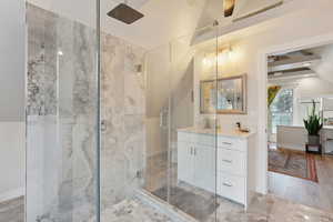 Bathroom with wood-type flooring, vanity, and walk in shower