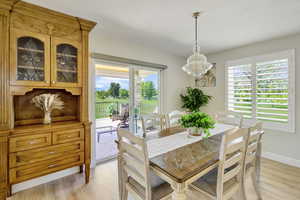 Dining area featuring a chandelier, light hardwood / wood-style flooring, and plenty of natural light