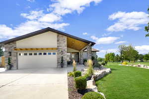 Contemporary house with a garage and a front lawn