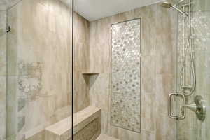 Bathroom with a textured ceiling and walk in shower