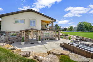 Back of property featuring french doors, a yard, an outdoor hangout area, a balcony, and a patio area