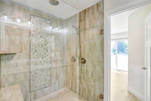 Bathroom with a shower with shower door and a textured ceiling