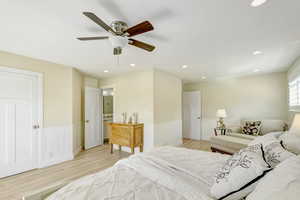 Bedroom with light hardwood / wood-style floors and ceiling fan