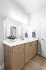 Bathroom featuring hardwood / wood-style flooring and vanity