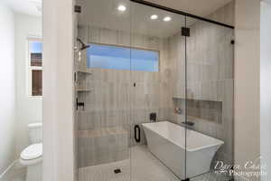 Bathroom featuring plus walk in shower and toilet