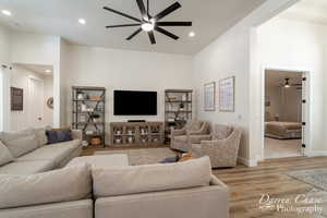 Living room featuring a towering ceiling and light hardwood / wood-style floors